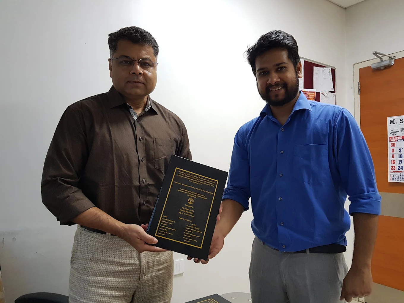 Dr. Nikhil Gupta presenting an academic achievement